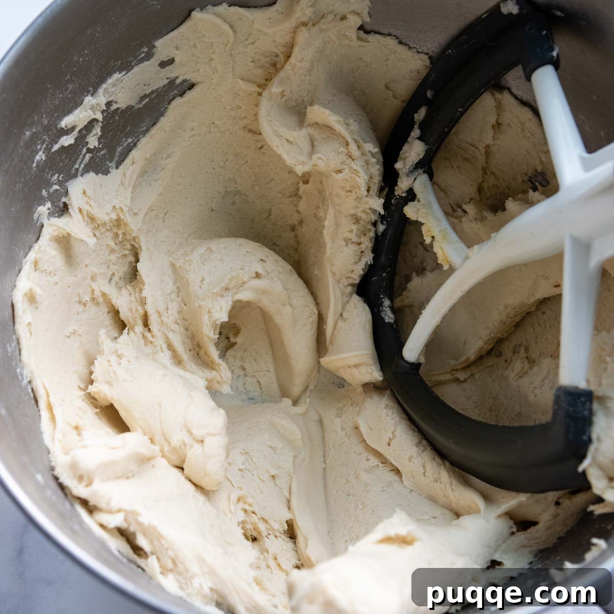 Pillowy Soft Gluten-Free Calzones 3 Gluten-free calzone dough in a mixing bowl, showcasing its firm yet slightly sticky consistency.