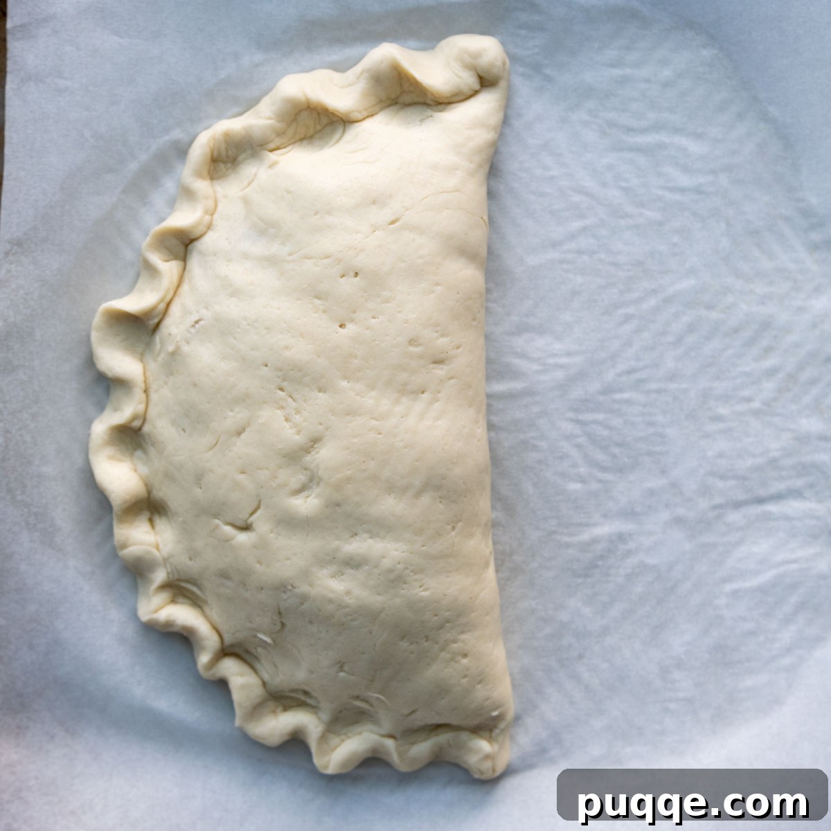 Pillowy Soft Gluten-Free Calzones 9 The edges of the calzone finished with a decorative flute pattern, resembling a traditional pie crust.