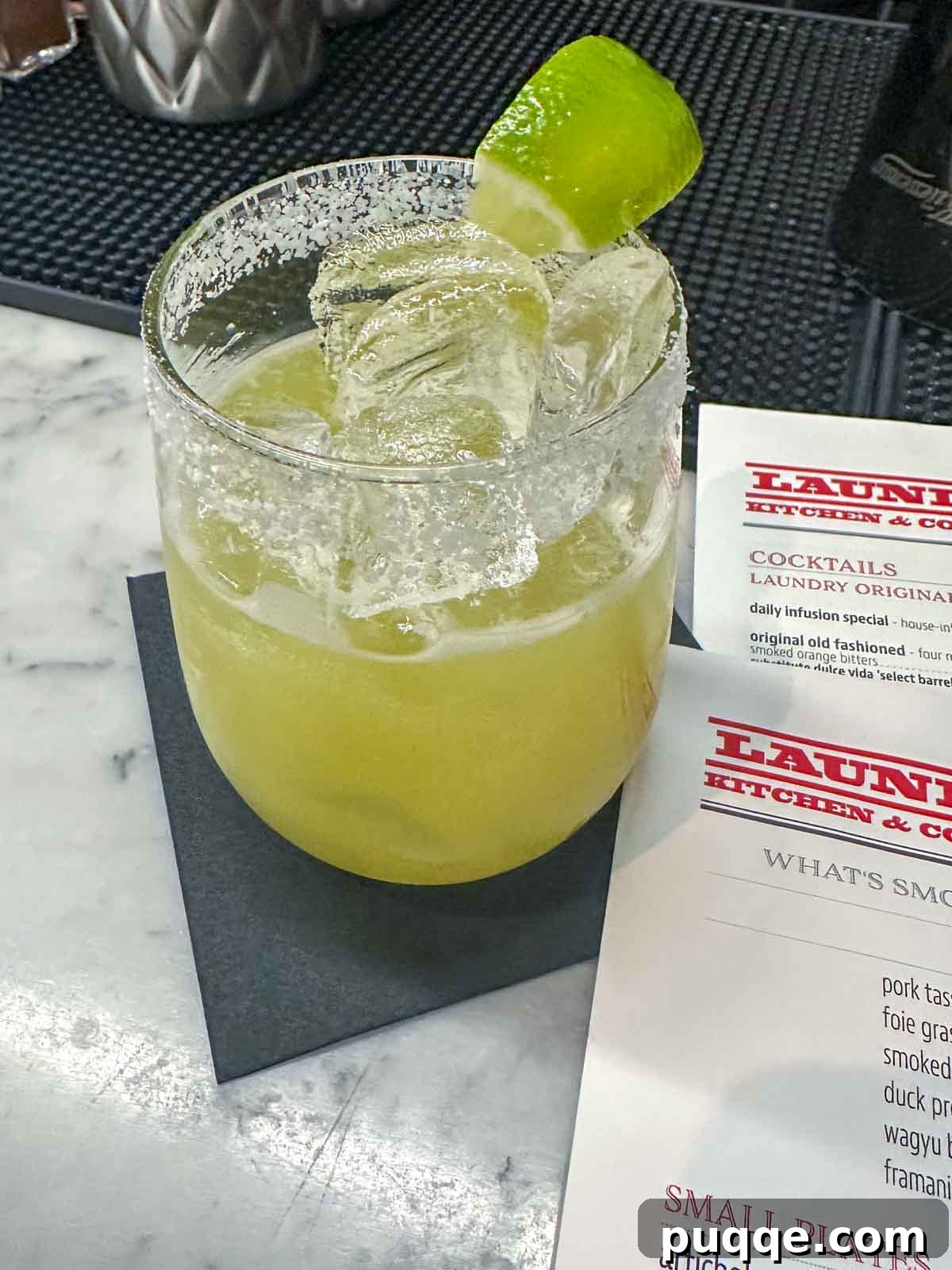 A vibrant Fiery Margarita cocktail on a menu at The Laundry Restaurant