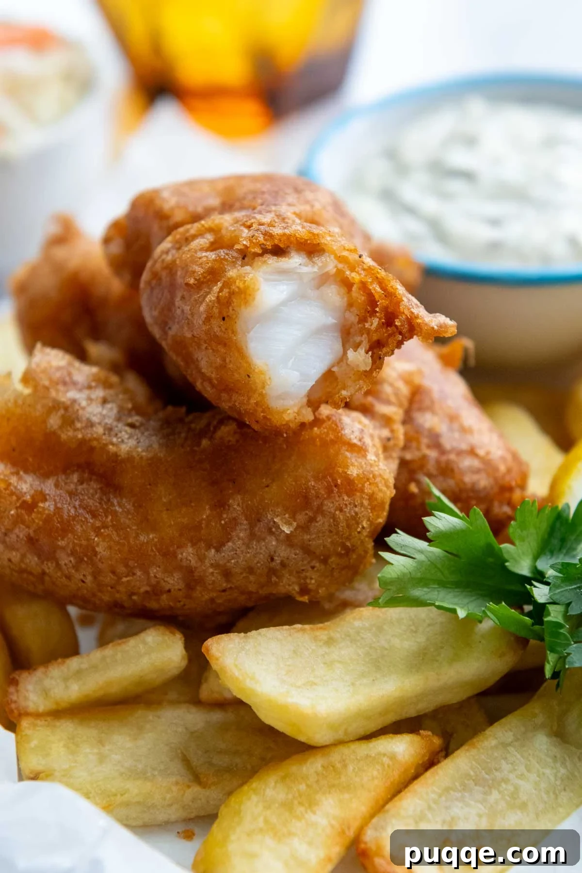 a serving of fried fish on french fries.