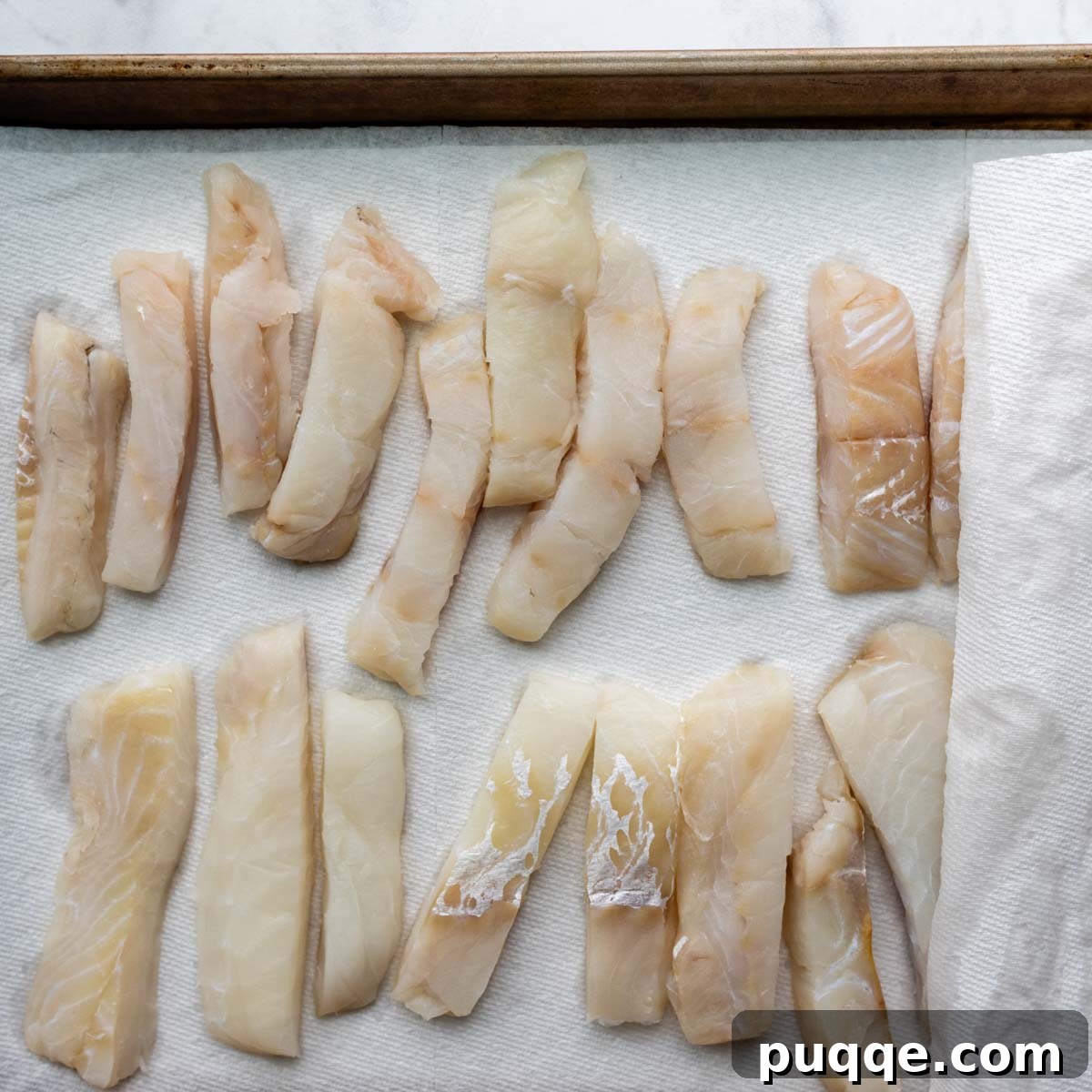 cut fish on a baking sheet lined with paper towels.
