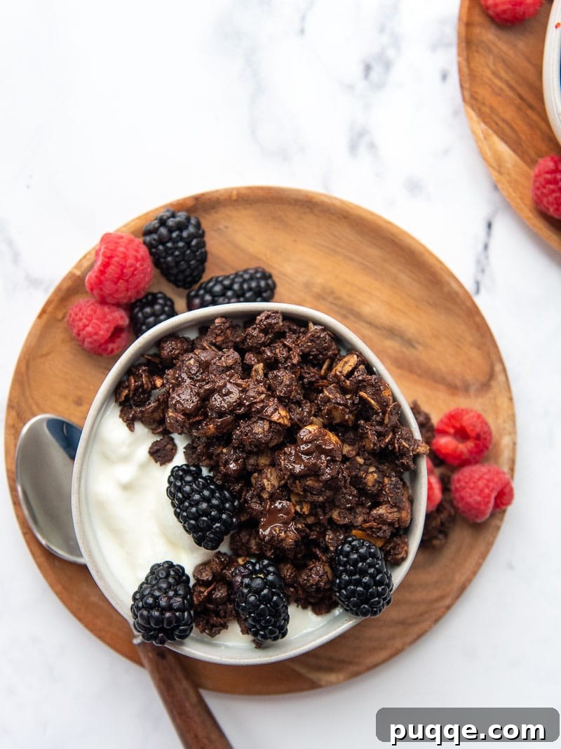 overhead shot of granola in a bowl with yogurt and berries