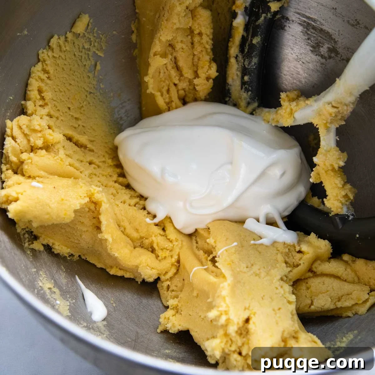 Thick almond flour cake batter, before egg whites are folded in, showing the initial consistency.