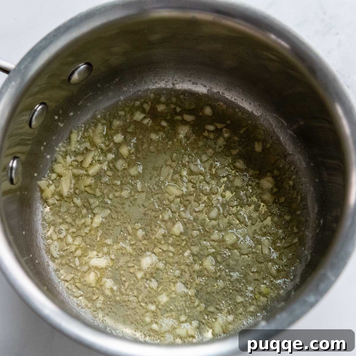garlic being sauted in butter.
