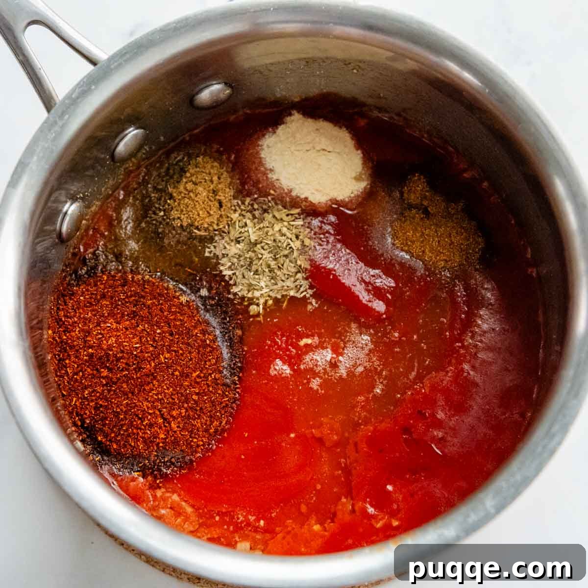 the tomato sauce and spices in a saucepan.