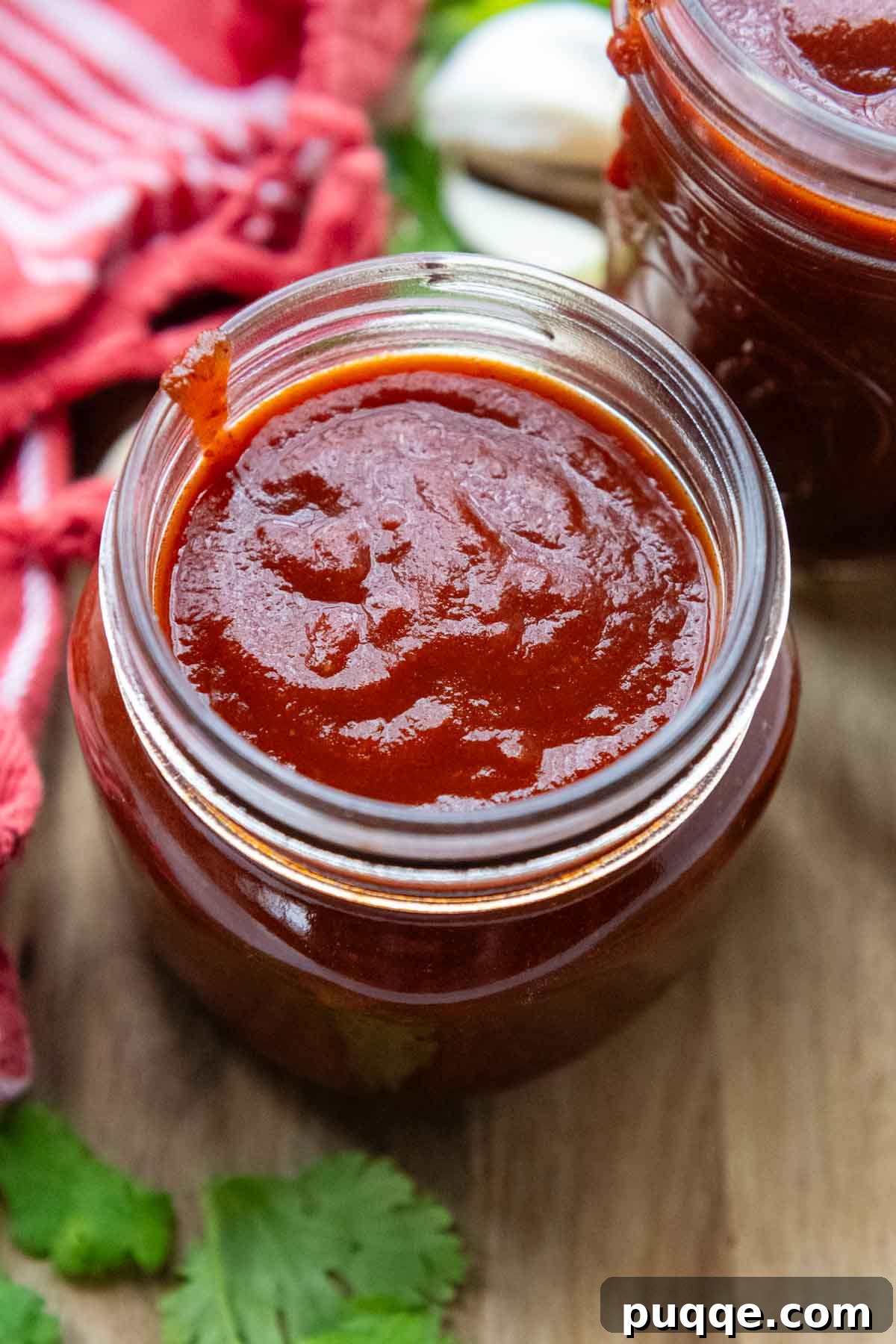 looking into the top of glass jar with enchilada sauce.
