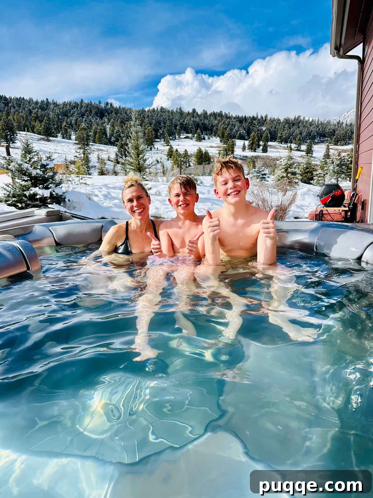 Big Sky Resort: The Ultimate Family Guide 4 Melissa Erdelac and kids relaxing in a private hot tub with stunning mountain views.