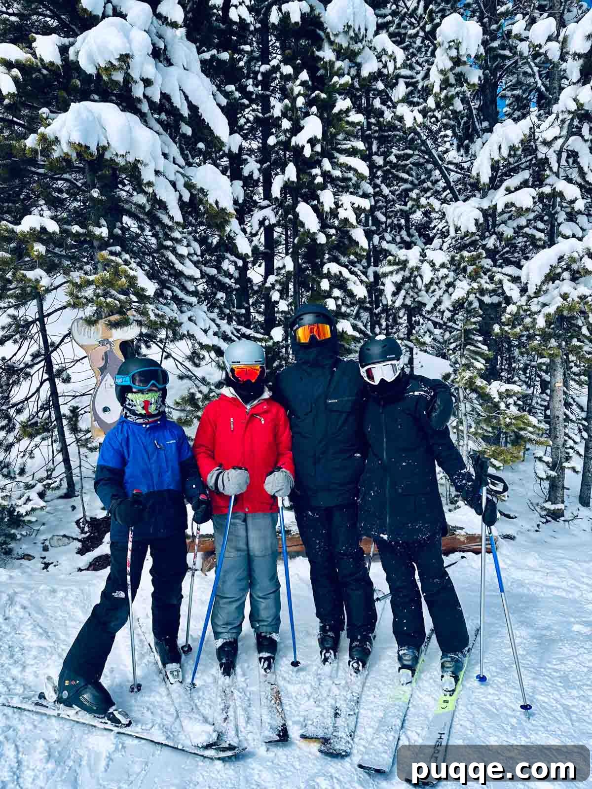 Big Sky Resort: The Ultimate Family Guide 5 Children posing proudly on a snowy ski run in Big Sky, Montana, with majestic mountains in the background.