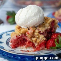 A slice of gluten-free strawberry pie with ice cream on top, and a bite taken out, showing the rich filling.