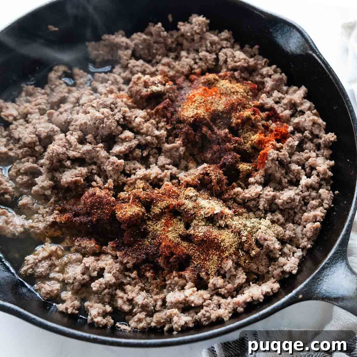 Revolutionary Gluten Free Weeknight Tacos 6 Seasoned ground beef simmering in a skillet, coated in a rich tomato sauce, ready to be transformed into delicious tacos.