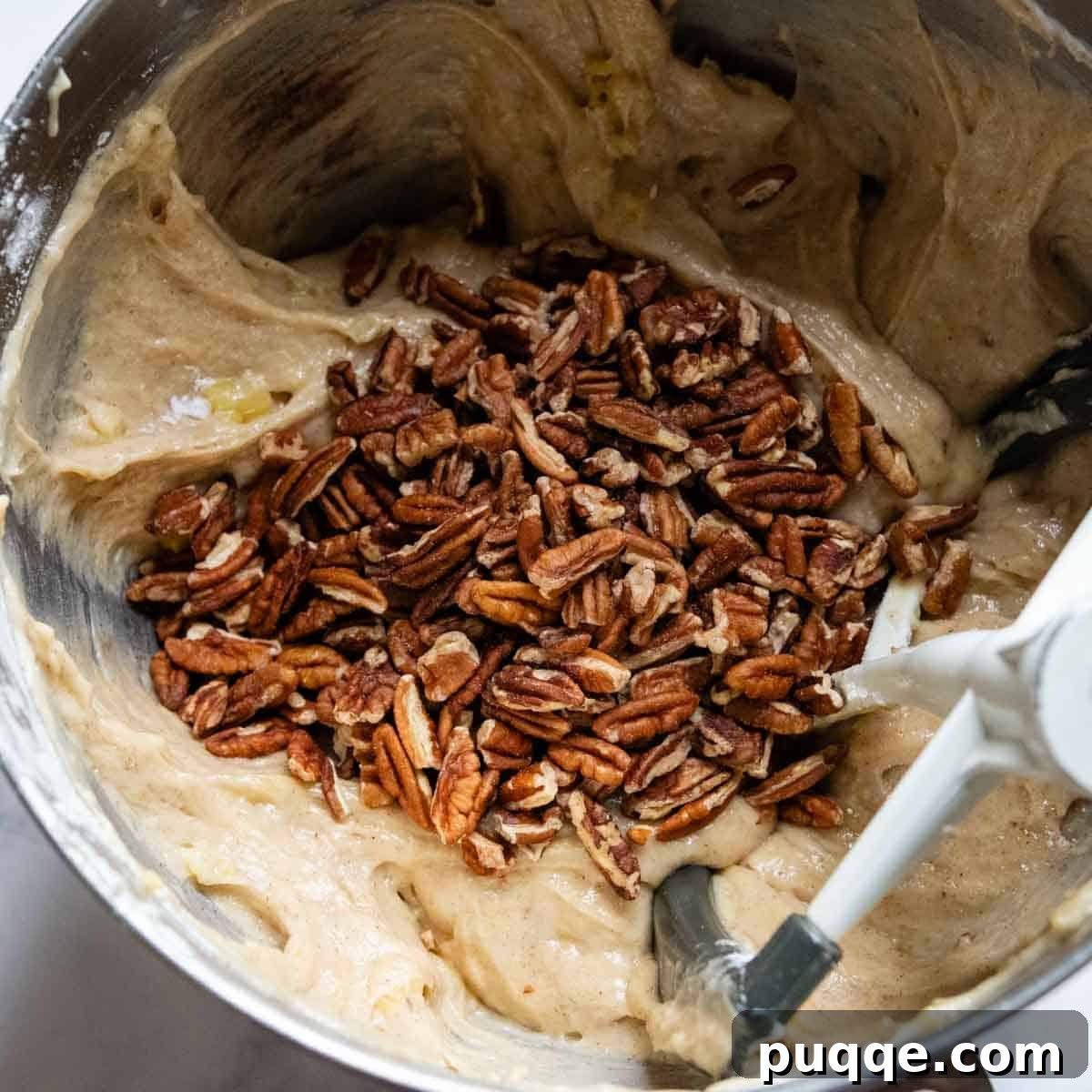 Tropical & Tender Gluten-Free Hummingbird Cake 5 Chopped pecans being mixed into the thick cake batter.