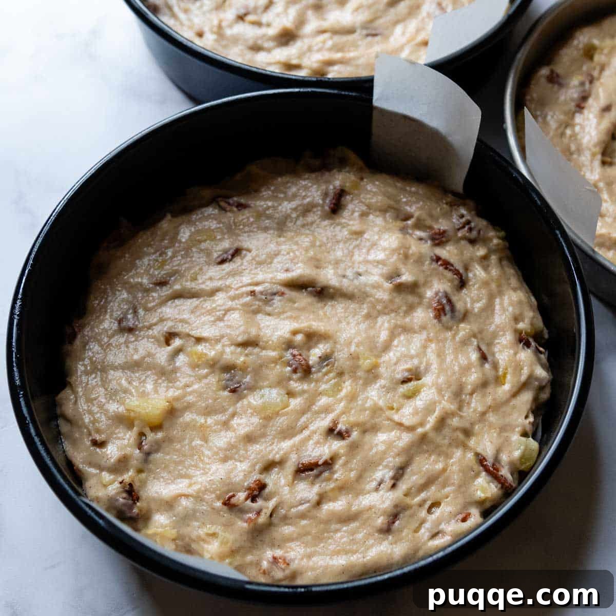 Tropical & Tender Gluten-Free Hummingbird Cake 6 Cake batter evenly spread into three round cake pans, ready for baking.