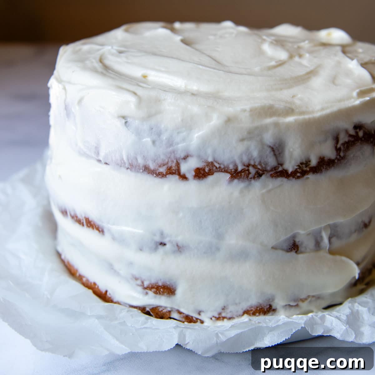 Tropical & Tender Gluten-Free Hummingbird Cake 8 A cake with a thin crumb layer of frosting applied, ready for chilling before the final frost.