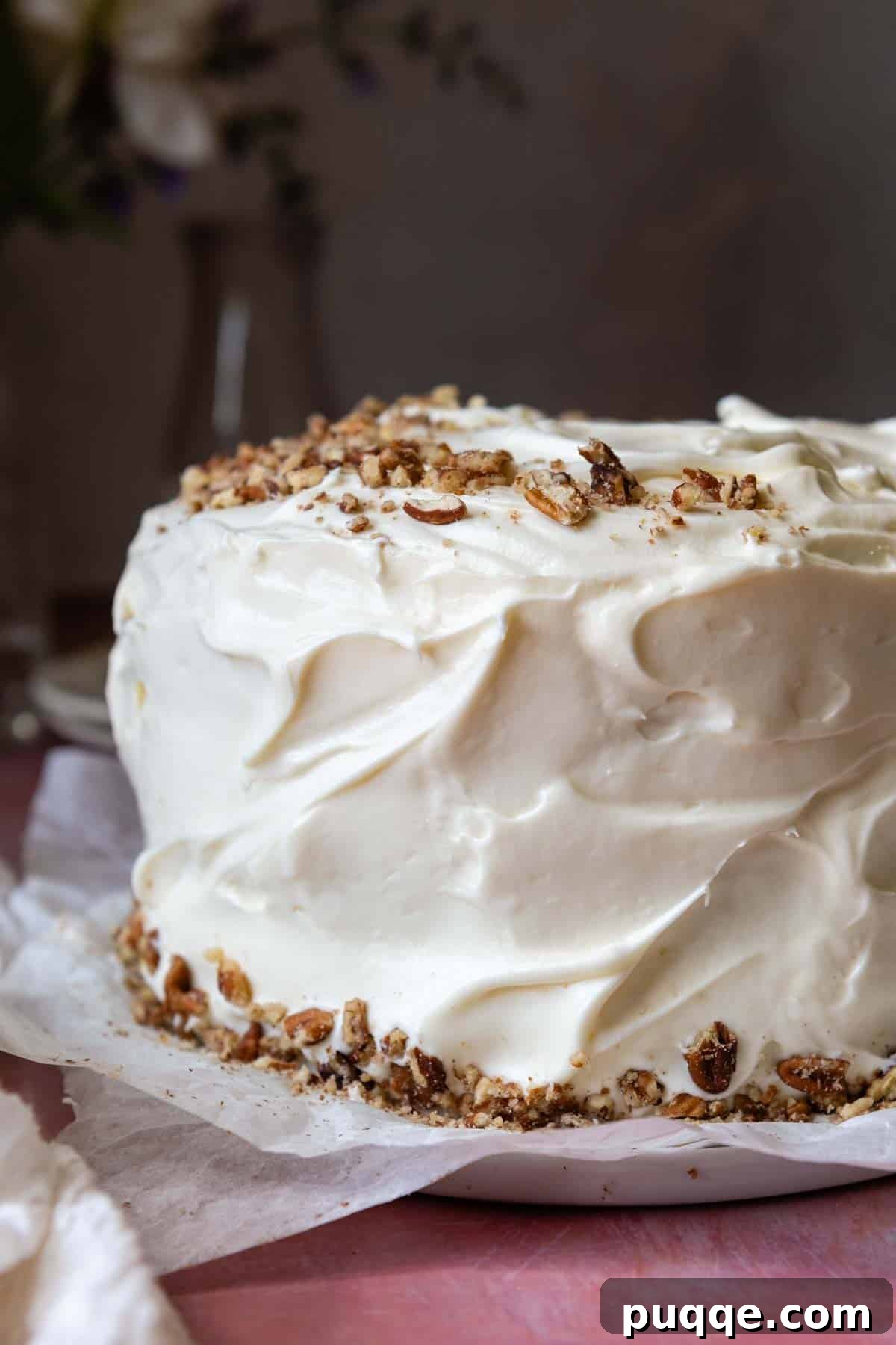 Tropical & Tender Gluten-Free Hummingbird Cake 9 A beautifully frosted gluten-free hummingbird layer cake adorned with chopped pecans on top and around the edges.