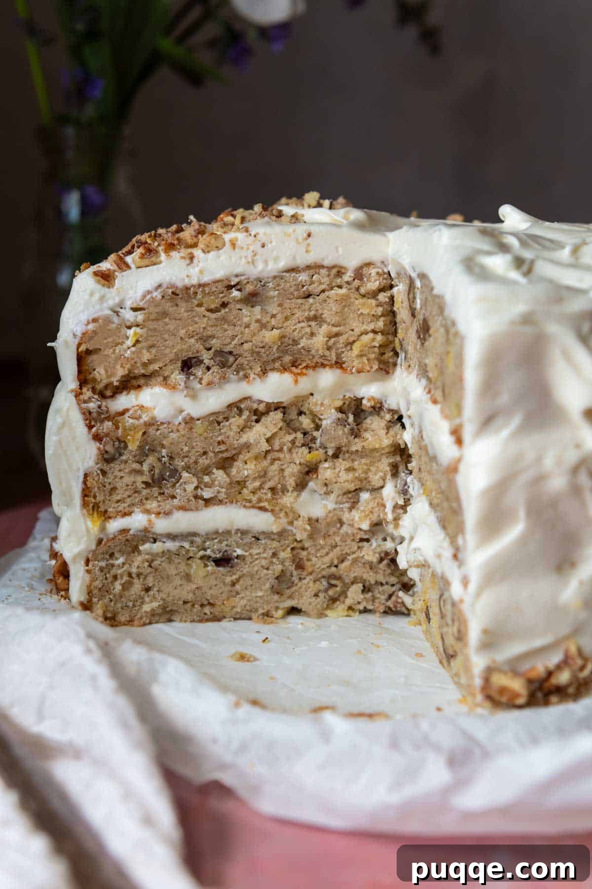 Tropical & Tender Gluten-Free Hummingbird Cake 10 A beautifully cut gluten-free hummingbird layer cake displayed on a platter, showcasing its moist interior and layered frosting.