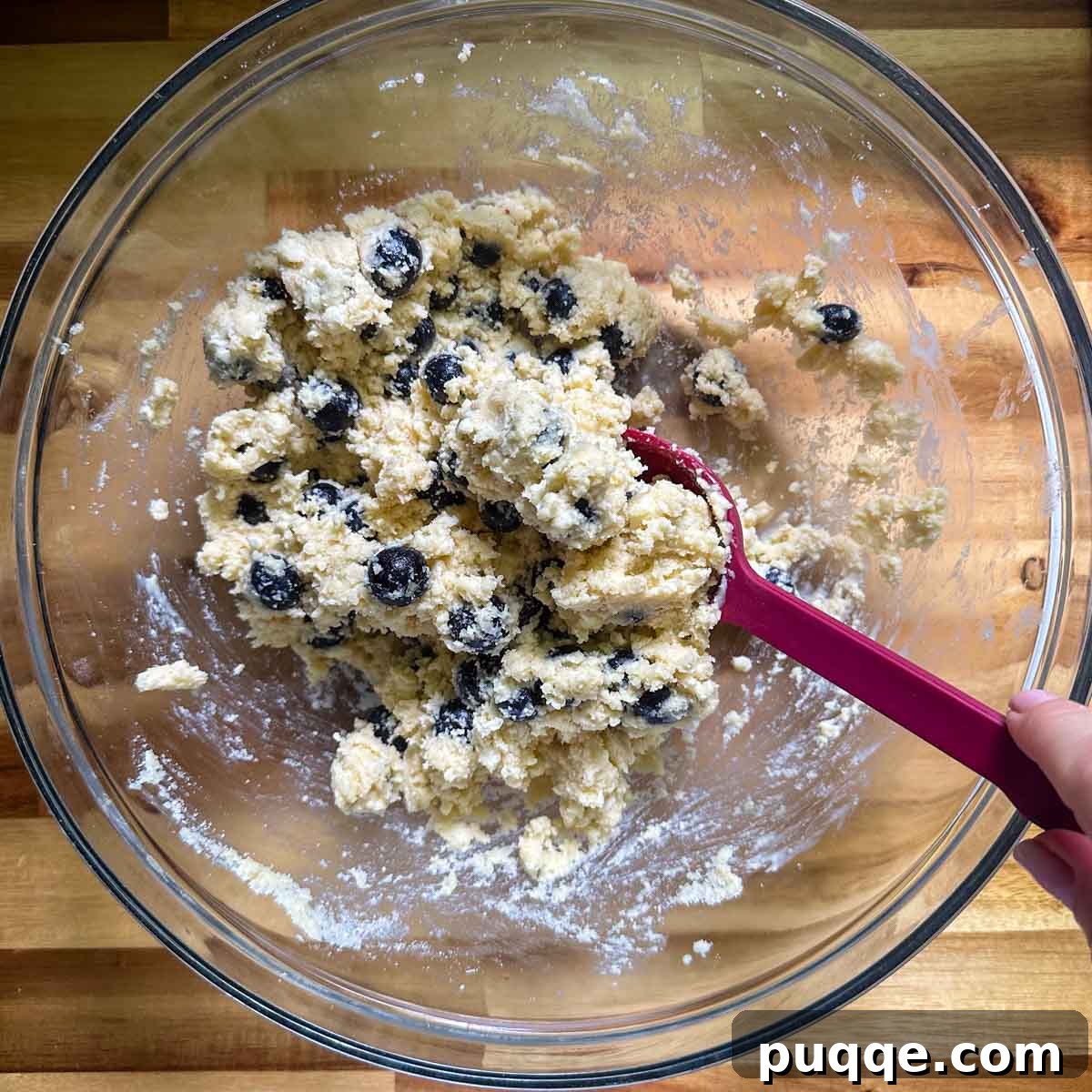 The wet ingredients being stirred into the dry mixture to form the scone dough.