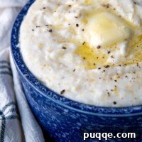 A close-up of butter melting on a bowl of grits, showcasing the creamy texture.