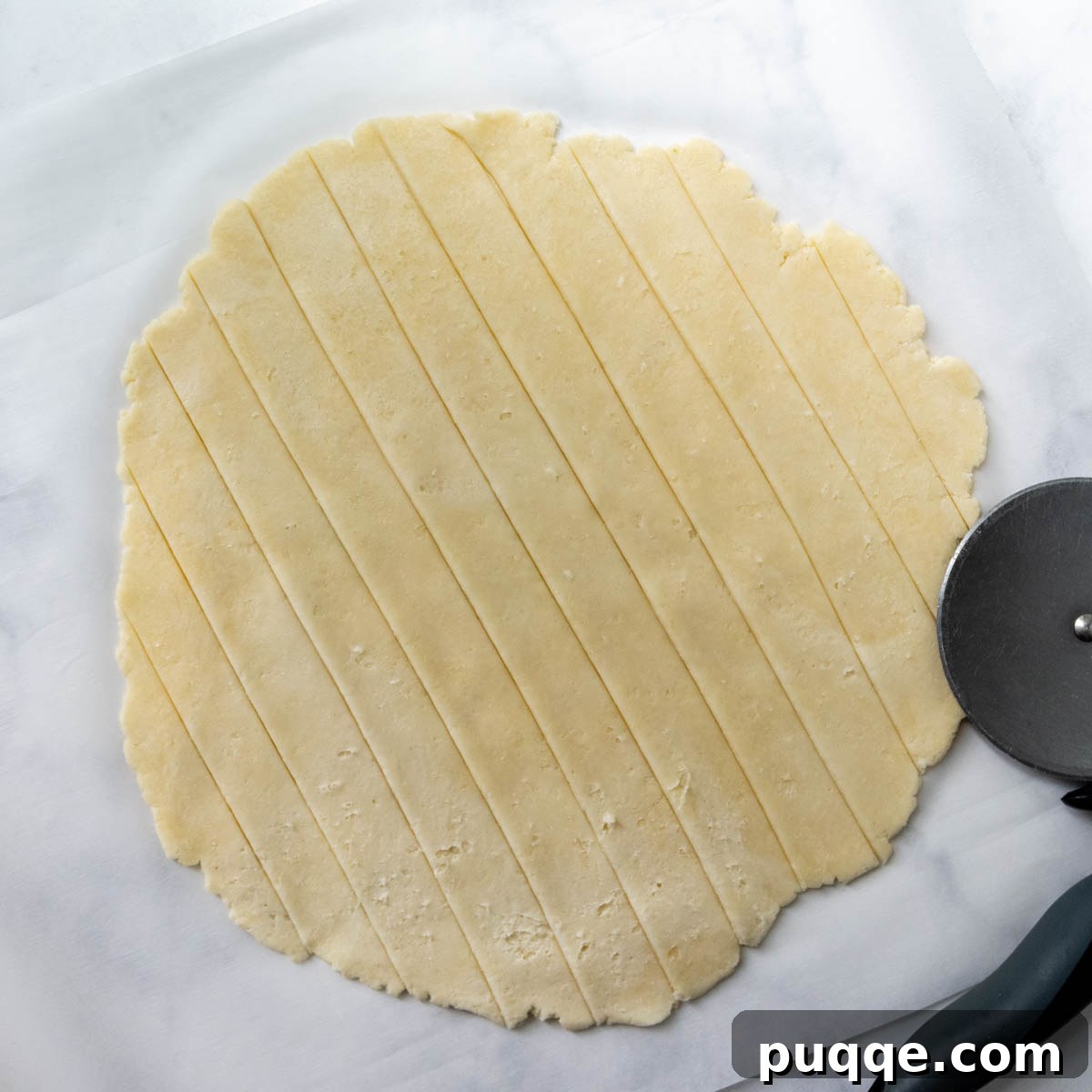 Uniform strips of pie crust, perfectly sliced and ready to be woven into a beautiful lattice top.