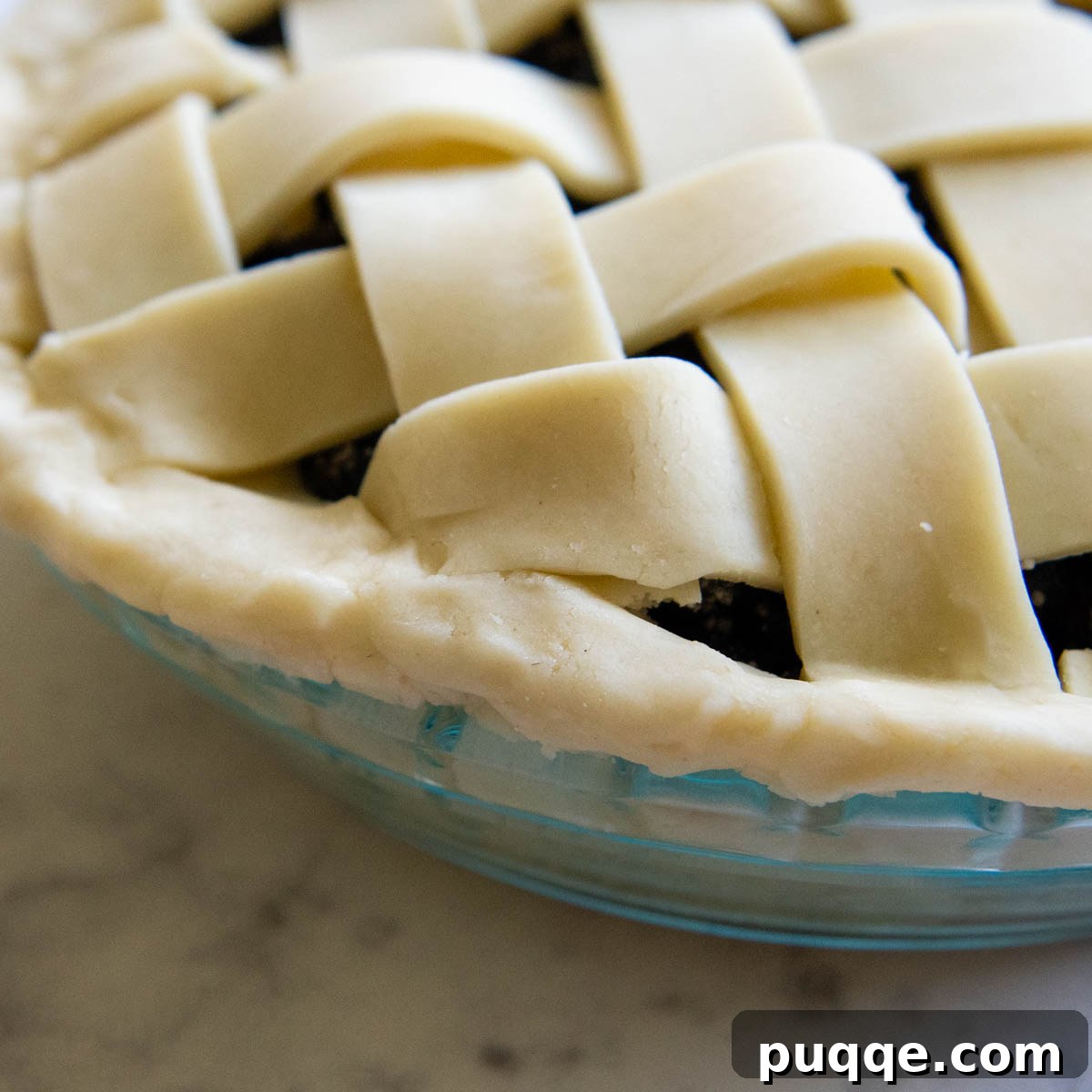 A detailed close-up of the pie crust edge before it has been artfully fluted or crimped.