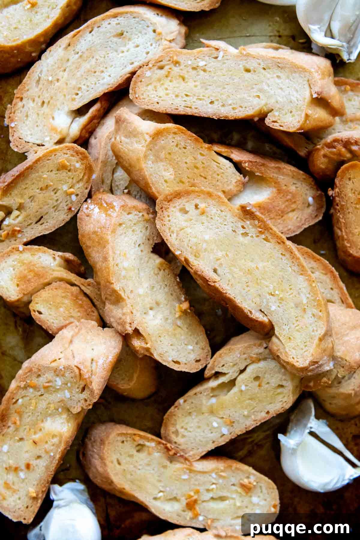 overhead shot of GF crostini with garlic cloves scattered around.