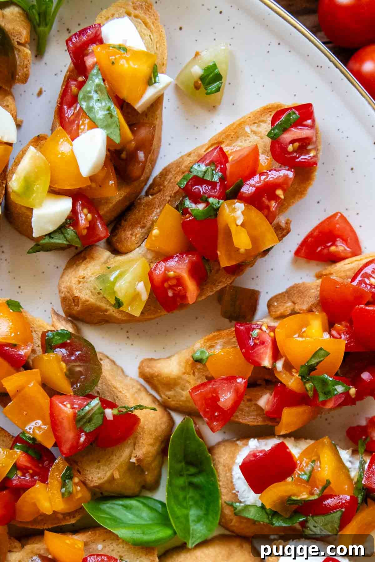 Savory Gluten-Free Italian Bruschetta 6 close up of a white platter with various types of bruschetta, some with cheese and some without.