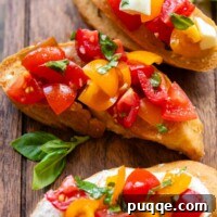 Savory Gluten-Free Italian Bruschetta 7 Three bruschetta slices on a wooden cutting board with fresh basil leaves.