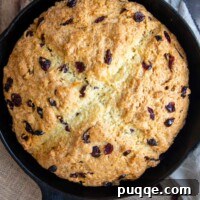 Melt-in-Your-Mouth Sweet Irish Soda Bread 9 A whole, unsliced Sweet Irish Soda Bread loaf in a black cast iron skillet.
