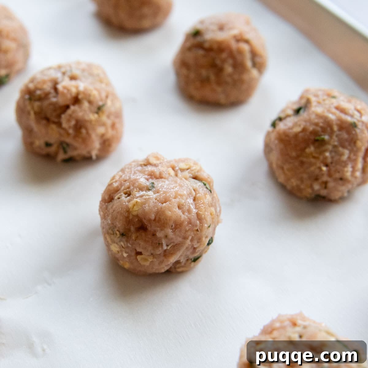 Crave-Worthy Gluten-Free Chicken Meatballs 4 Raw chicken meatballs, perfectly shaped and ready for baking, arranged neatly on a parchment-lined baking sheet.