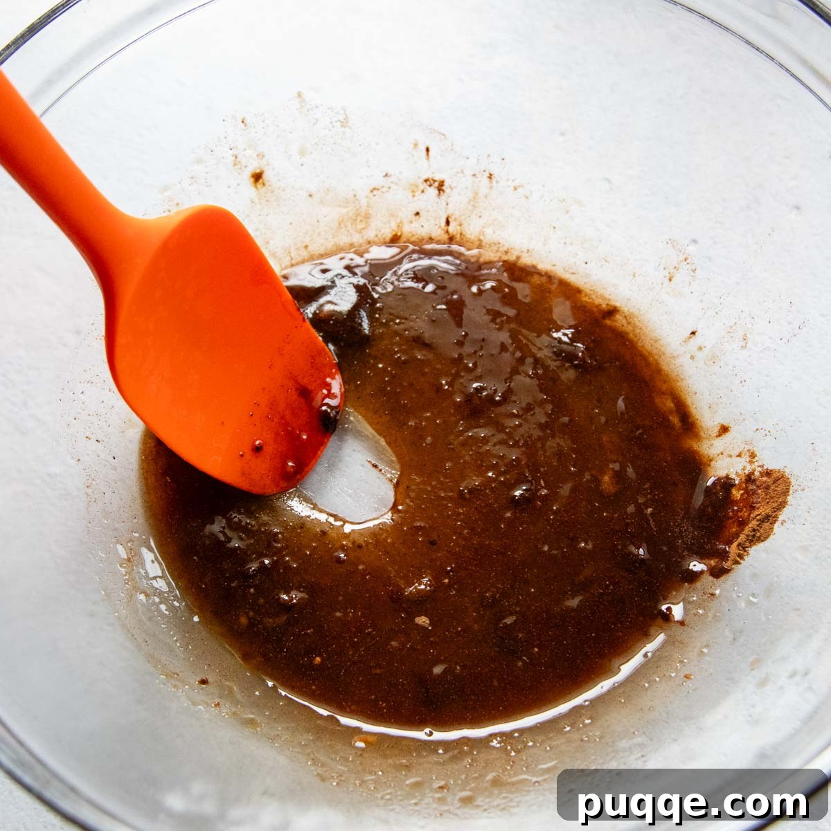 Heavenly Spiced Gluten-Free Muesli Bliss 3 Wet ingredients for the spiced muesli coating, including maple syrup, oil, vanilla, and various spices, mixed in a bowl.