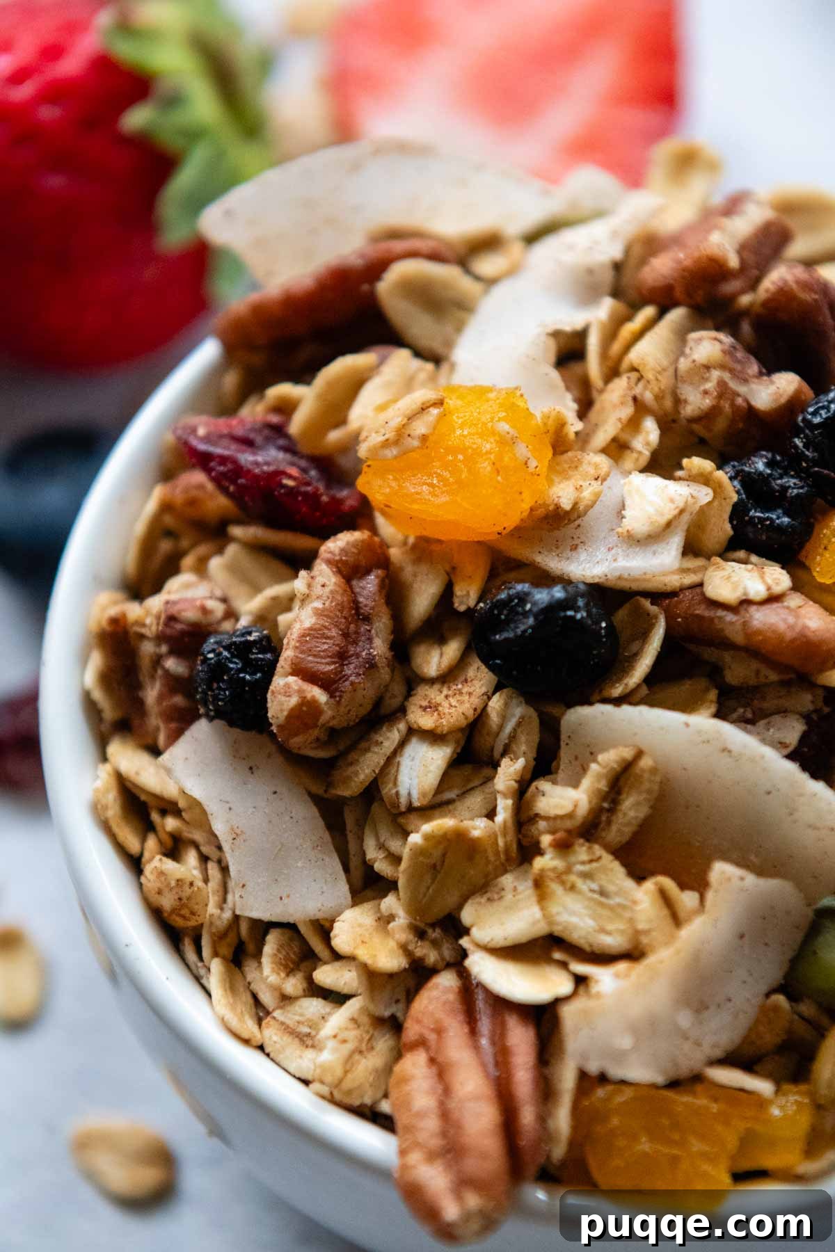 Heavenly Spiced Gluten-Free Muesli Bliss 6 A bowl of gluten-free muesli, generously topped with an assortment of dried fruits and nuts, ready to be enjoyed.