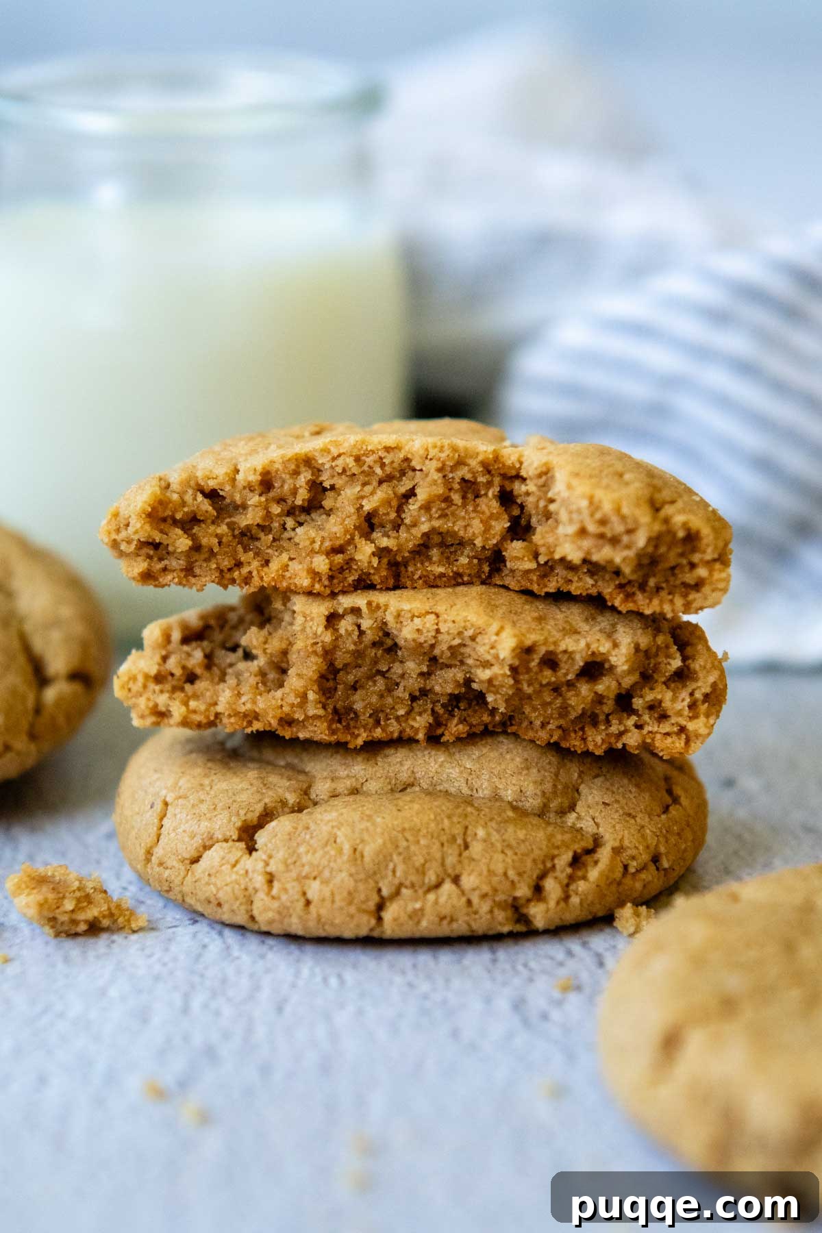 Melt-in-Your-Mouth Peanut Butter Oat Flour Cookies 7 Two perfectly baked oat flour peanut butter cookies, artfully broken apart and stacked, revealing their soft, chewy interior.