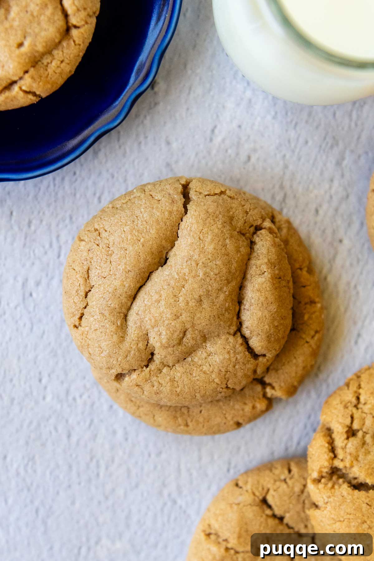Melt-in-Your-Mouth Peanut Butter Oat Flour Cookies 8 An inviting overhead shot of perfectly stacked oat flour peanut butter cookies, showcasing their golden-brown edges and soft centers.
