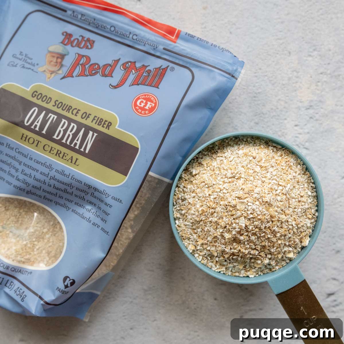 Velvety Maple Oat Bran Gluten-Free Morning Bliss 3 A measuring cup filled with gluten-free oat bran, placed alongside its original packaging, indicating preparation.