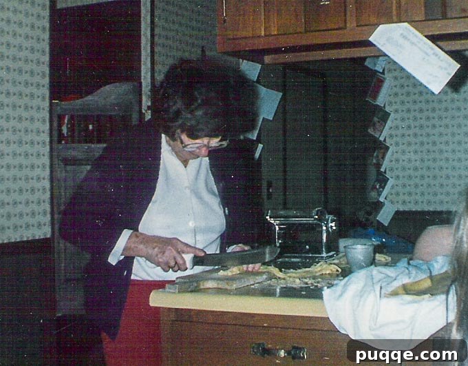Gramma skillfully making fresh pasta in our kitchen, a tradition passed down through generations