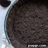 gluten-free oreo crust in a glass pie dish