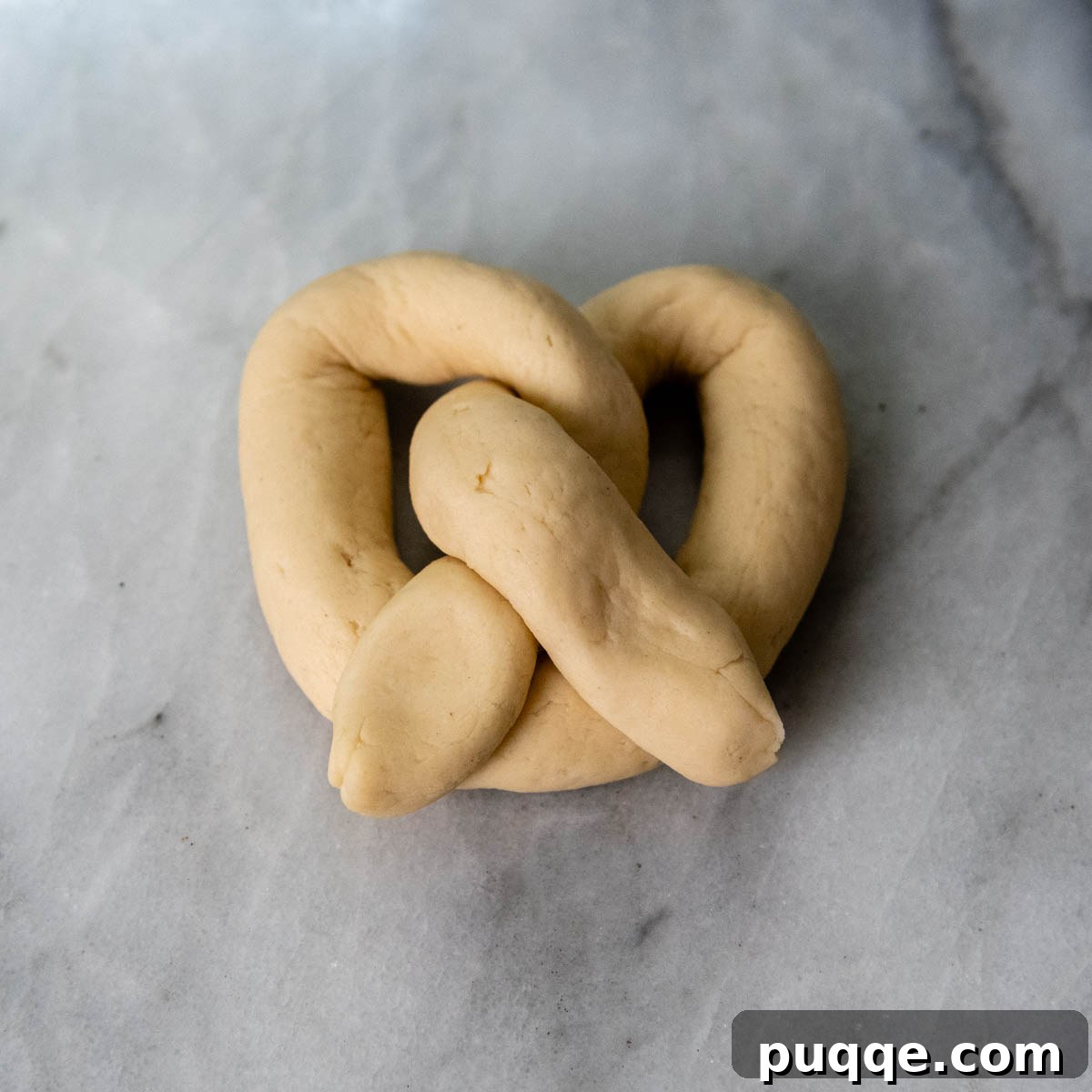 Pillowy Soft Gluten-Free Pretzels Simple Recipe 11 An unbaked gluten-free pretzel dough, completely twisted into the classic pretzel shape.