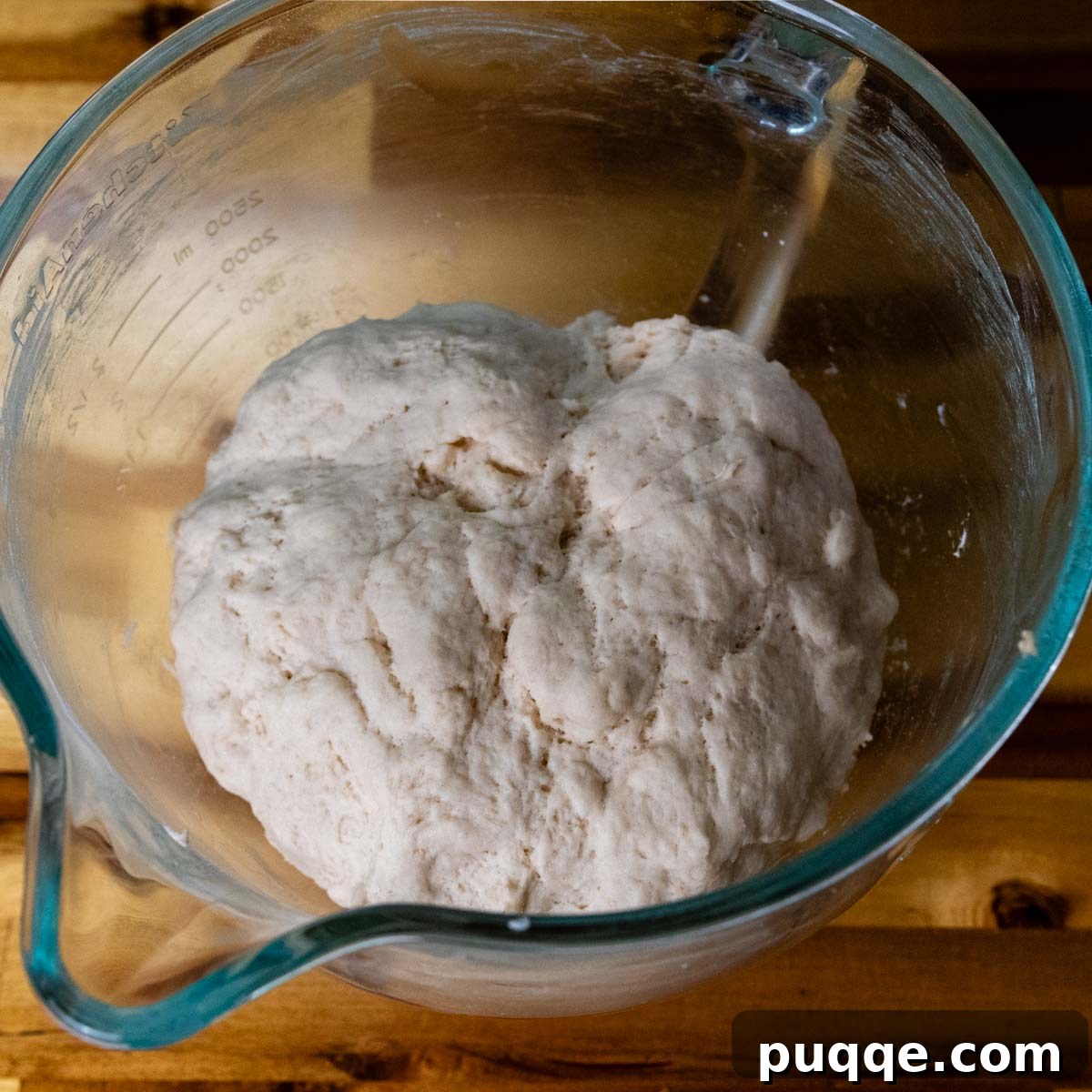 Pillowy Soft Gluten-Free Pretzels Simple Recipe 6 Risen gluten-free pretzel dough in a glass bowl, demonstrating its doubled size and readiness for shaping.