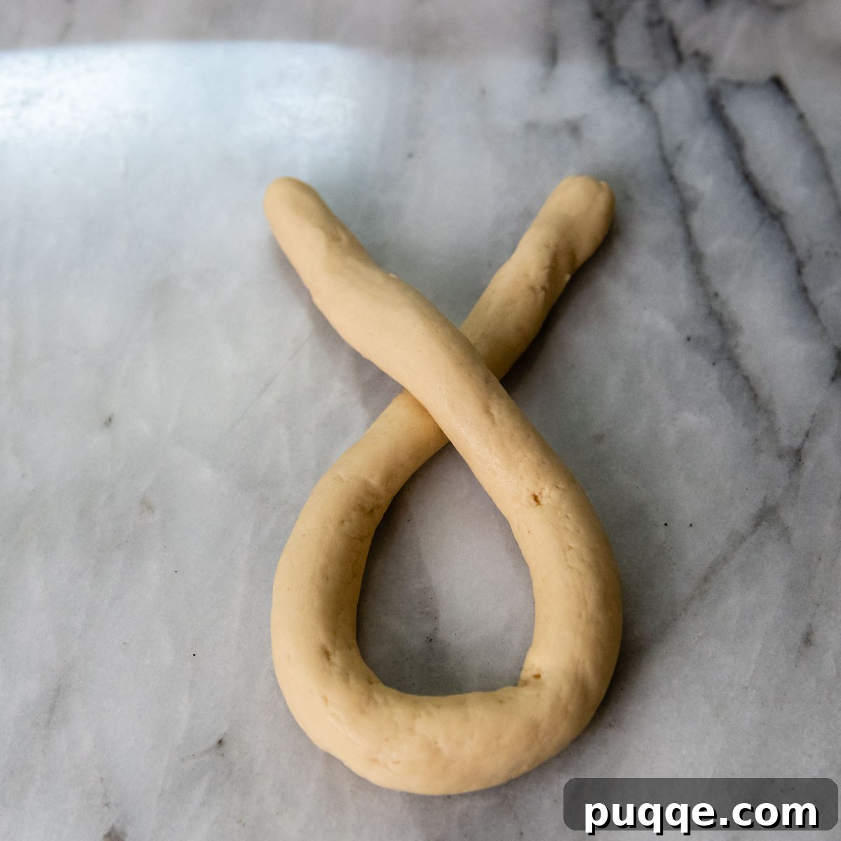 Pillowy Soft Gluten-Free Pretzels Simple Recipe 9 The ends of the dough rope crossed over one another, forming the first twist.