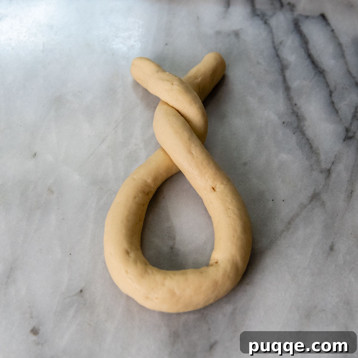 Pillowy Soft Gluten-Free Pretzels Simple Recipe 10 Dough with the ends fully twisted twice, showing the intertwined section.