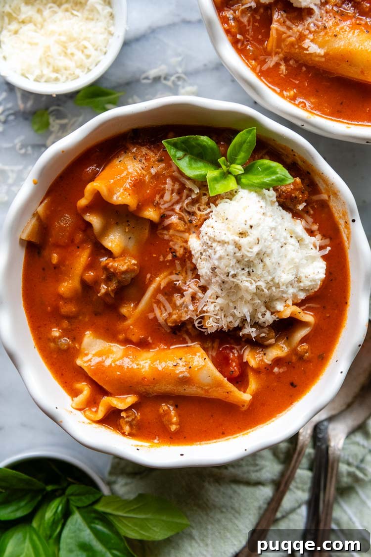 Ultimate 30-Minute Gluten-Free Lasagna Soup 6 An inviting overhead shot of the finished gluten-free lasagna soup, served in a white bowl and beautifully garnished with fresh basil leaves. A perfect comforting meal.