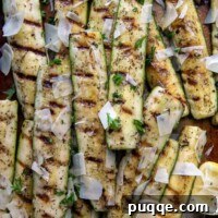 Summer's Best Grilled Zucchini and Squash 6 overhead shot of grilled zucchini and squash on a sheet pan with a serving utensil underneath