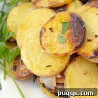A close-up of grilled potatoes on a white plate garnished with parsley