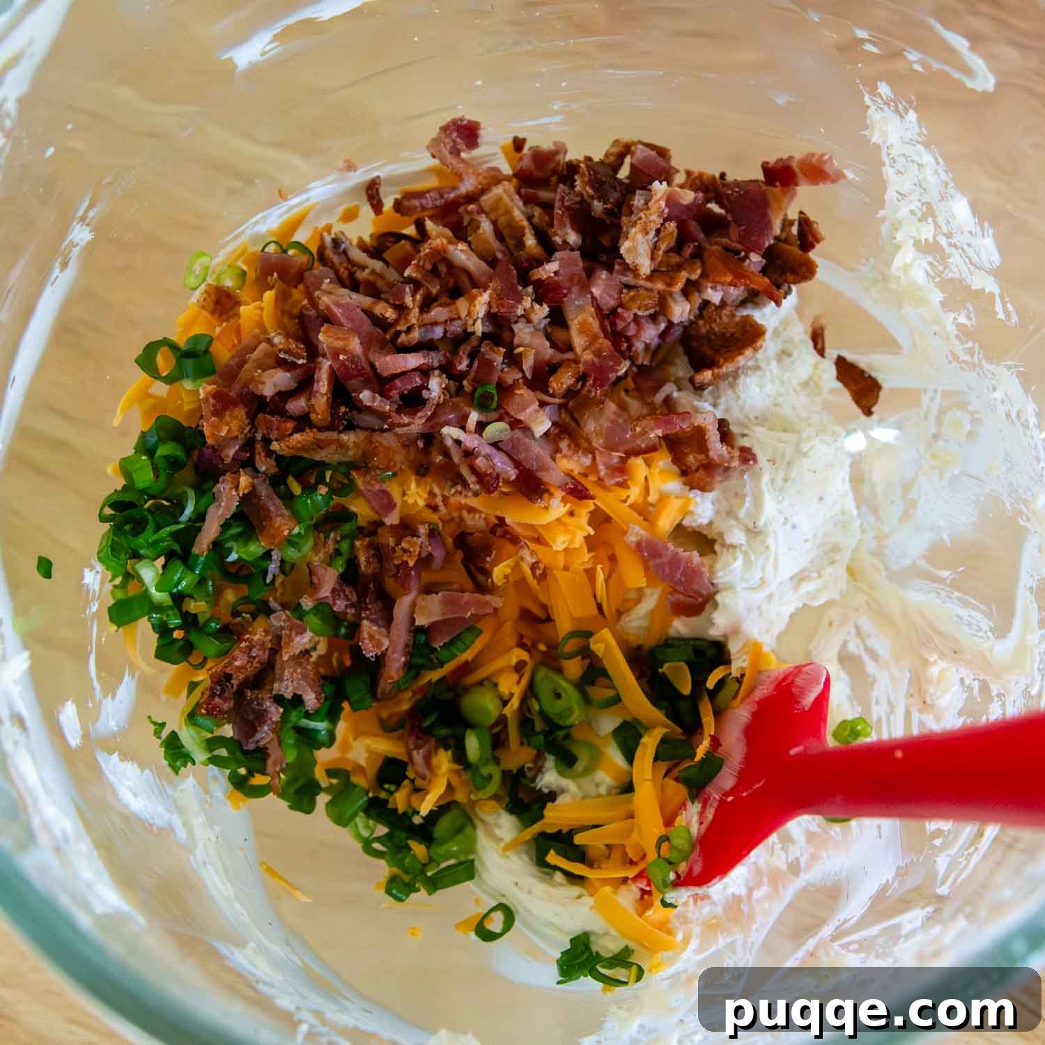 Crispy Baked Gluten-Free Jalapeño Poppers (Grain-Free) 5 All the jalapeño popper filling ingredients, including softened cream cheese, spices, green onion, cheddar cheese, and bacon, mixed together in a glass bowl.