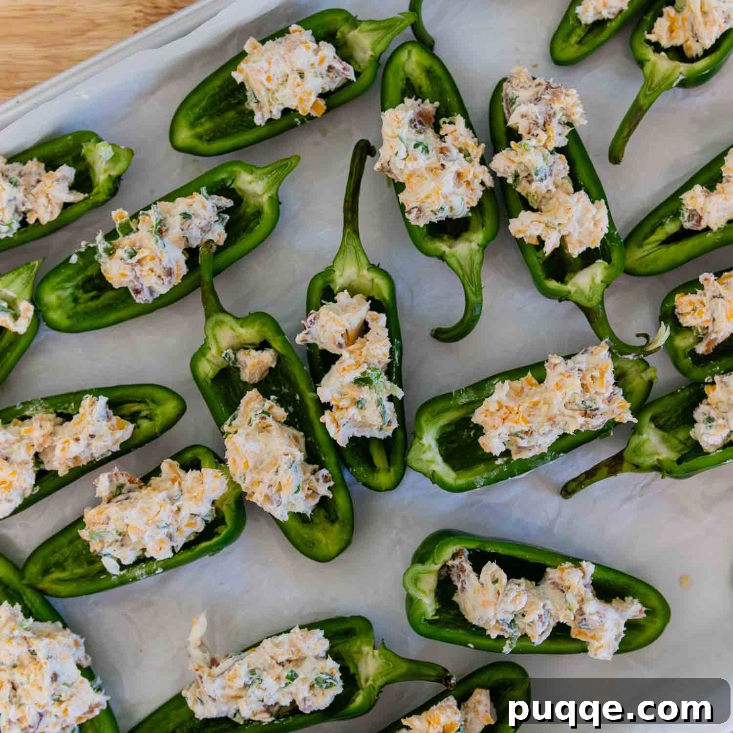 Crispy Baked Gluten-Free Jalapeño Poppers (Grain-Free) 6 Jalapeño halves neatly filled with the cream cheese, cheddar, and bacon mixture on a parchment-lined baking sheet.