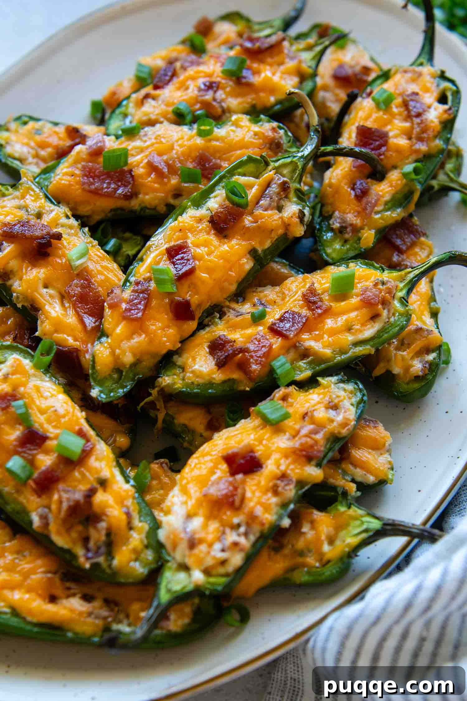 Crispy Baked Gluten-Free Jalapeño Poppers (Grain-Free) 9 A serving plate filled with multiple cooked and golden-brown jalapeño poppers, ready for guests.
