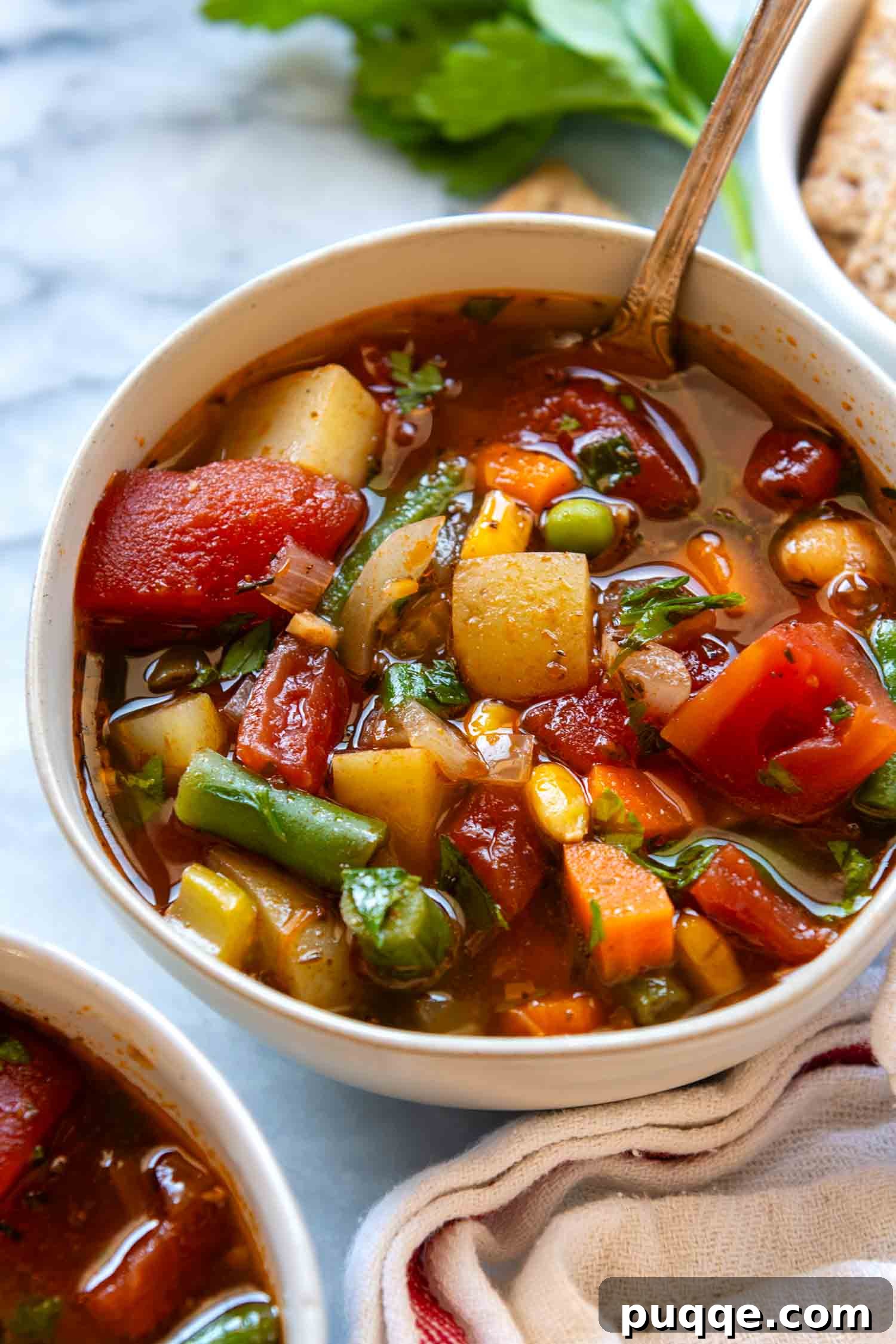 A steaming bowl of hearty gluten-free vegetable soup, garnished with fresh herbs, ready to be enjoyed.