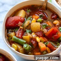 Gluten-Free Vegetable Soup ready to eat in a white bowl.