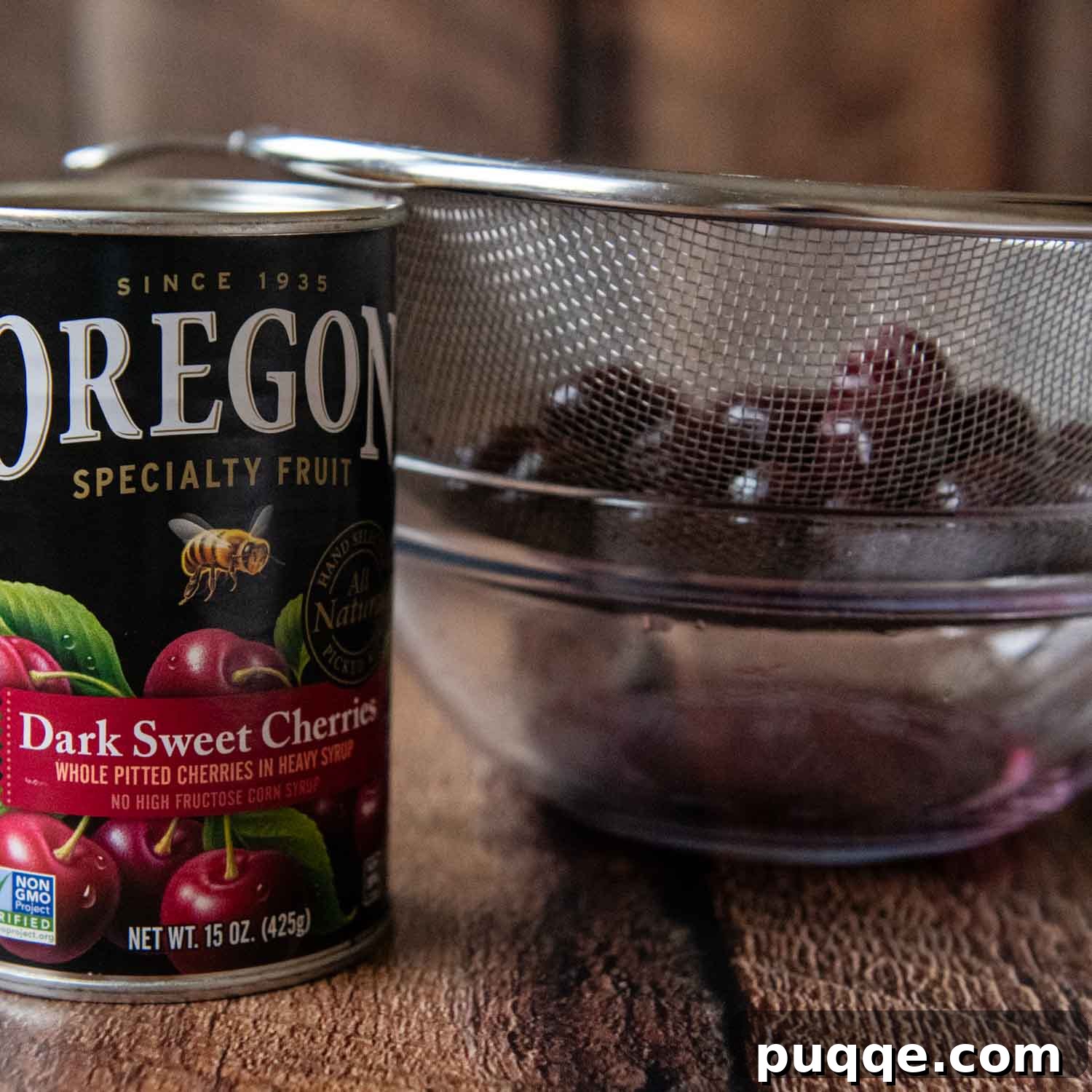 Ingredients for the cherry topping, including canned cherries and Kirsch cherry liqueur, arranged neatly.