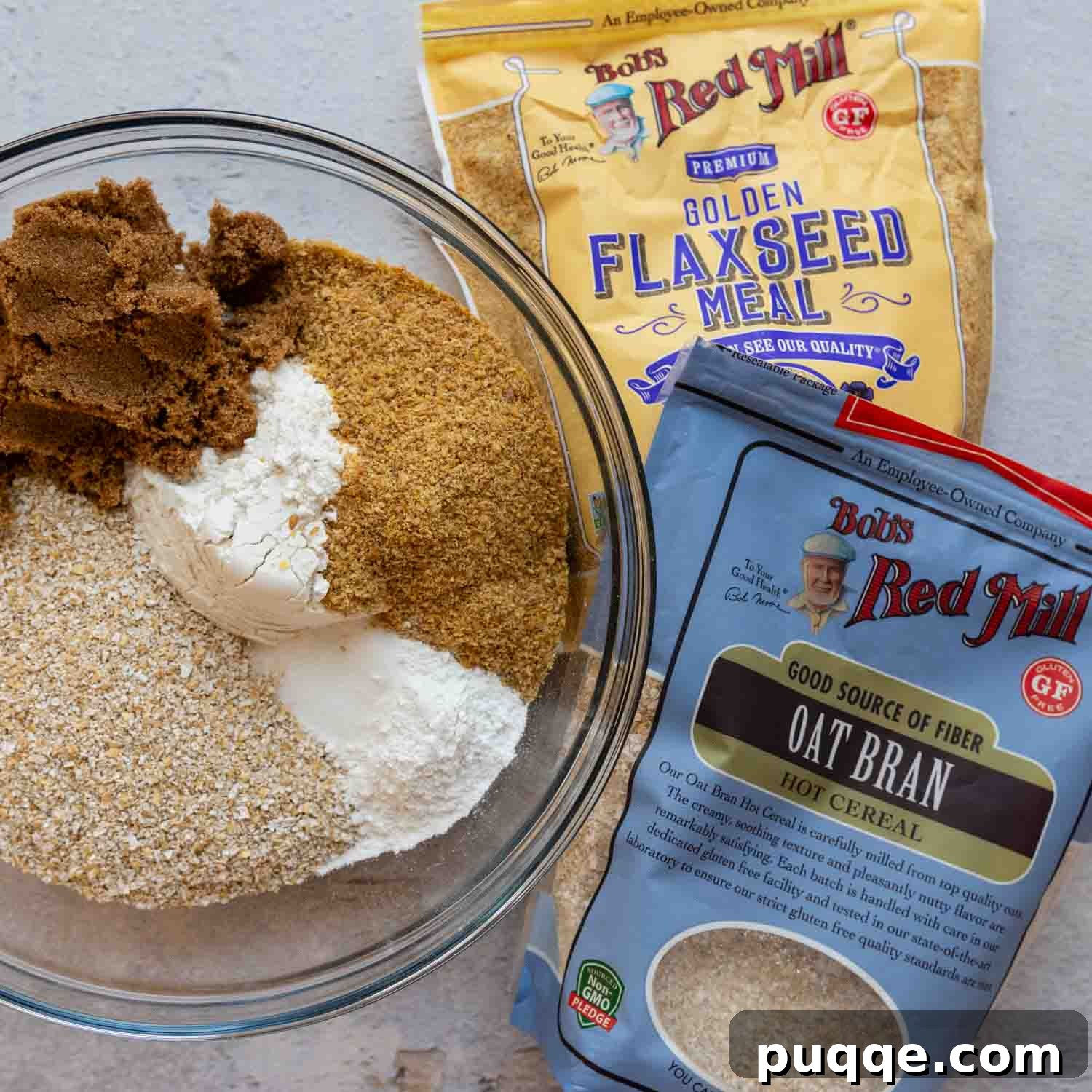Dry muffin ingredients and packages laid out on a surface.