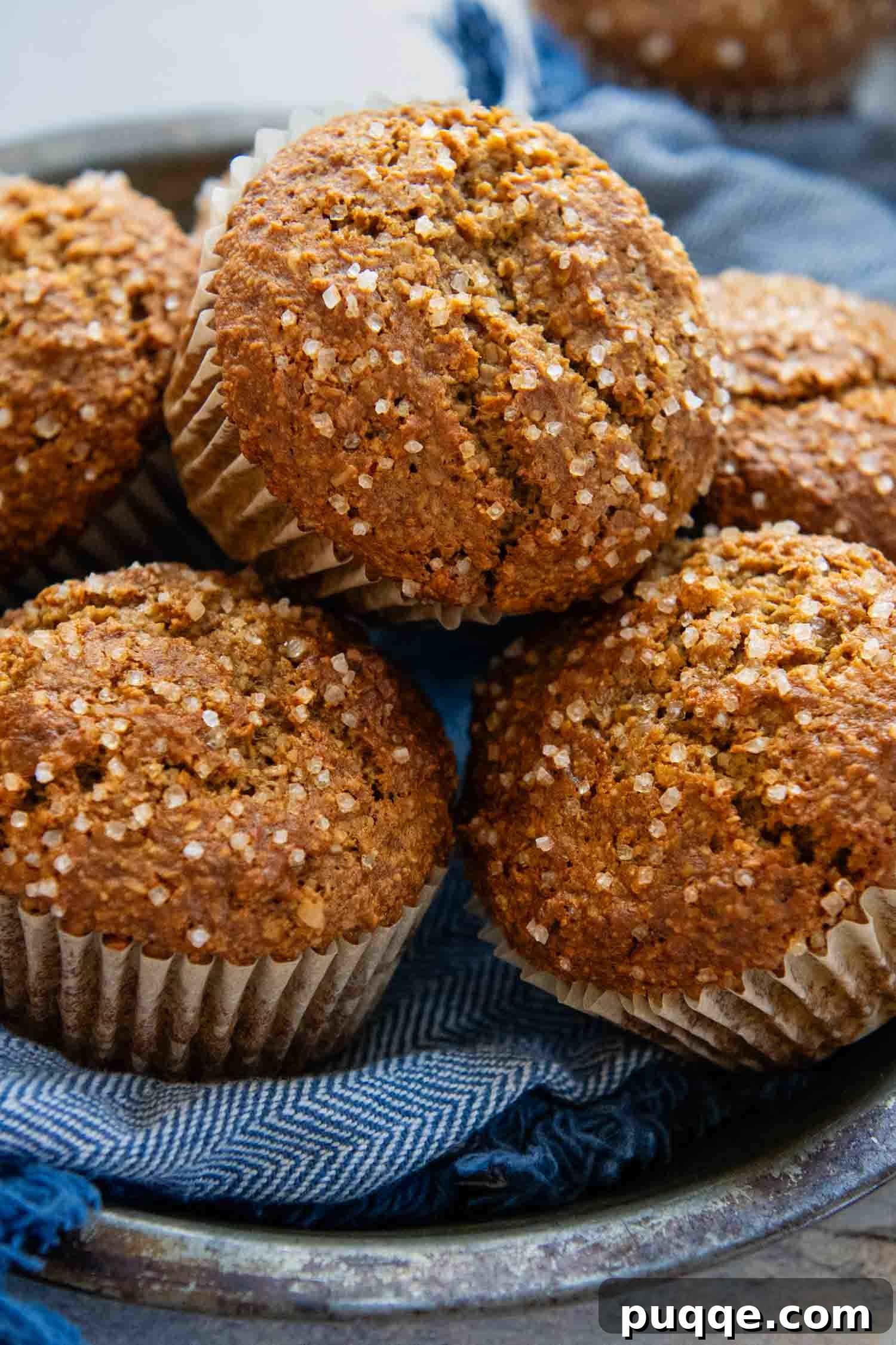 Gluten-free oat bran muffins stacked on a plate, ready to be enjoyed.
